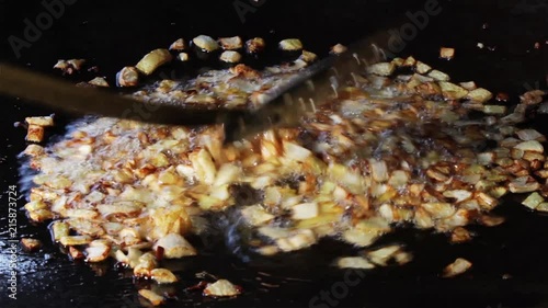 Roasted onion in baking tray on open fire 