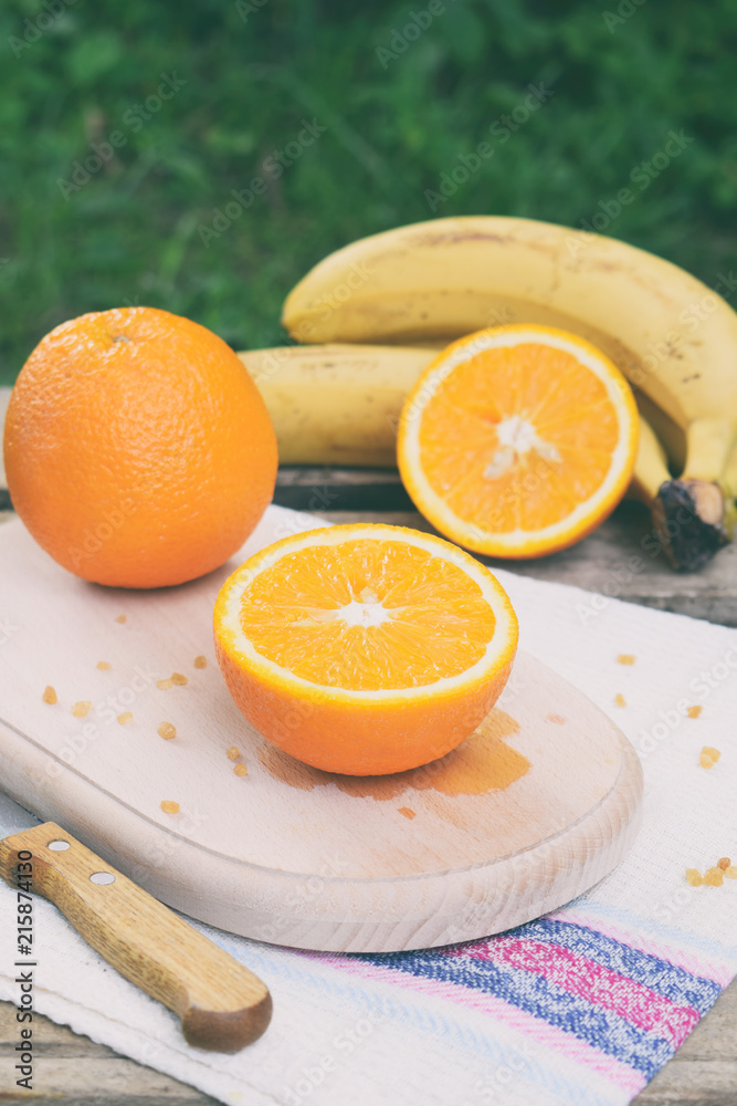 Orange juicy oranges on a wooden background. Whole and cut in half. Healthy food. Fresh organic fruits. Source of vitamin C. Copy space Orange juicy oranges on a wooden background. Whole and cut in half. Healthy food. Fresh organic fruits. Source of vitamin C. Copy space