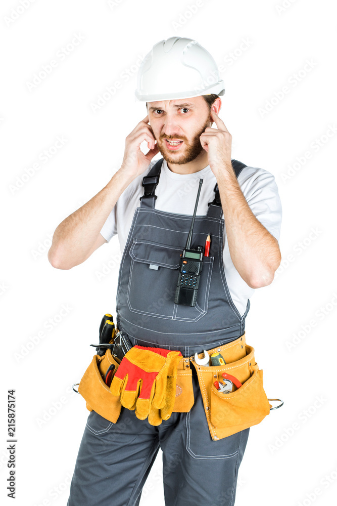 A builder or an employee in a protective helmet is listening. Isolated over white background. A builder or an employee in a protective helmet is listening. Isolated over white background.