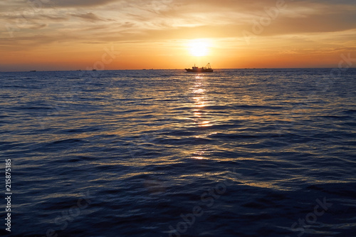 Cruise ship at sea, in sunset time photo