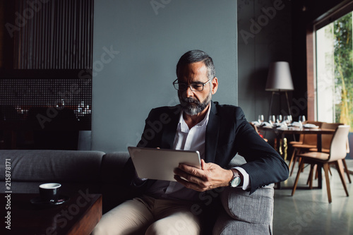 Businessman Reading on Tablet photo