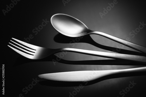 Set of stainless steel cutlery on a black reflective background, Restaurant concept