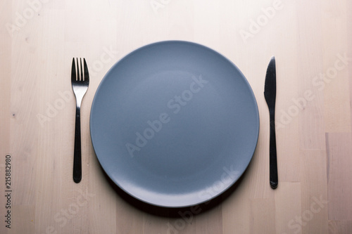 Top view of a restaurant table with plate, knife and fork, restaurant concept
