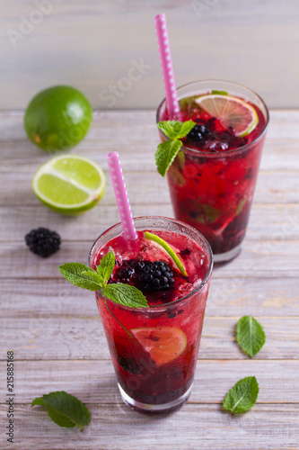 Blackberry mojito cocktail with berries, lime and mint. Summer berry cocktail