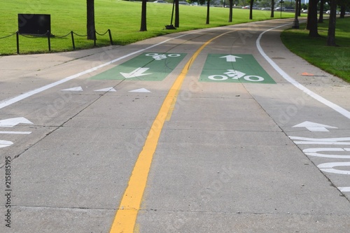 bike path curves through park with lane markings on concrete