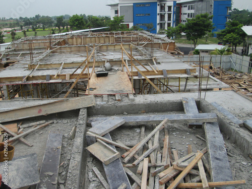 Photography Wet concrete is allowed to harden in wooden form work as the mold