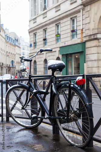 Bicycle covered with snow in a freezing winter day in Paris photo