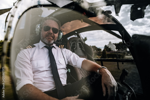 Pilot sitting in the cockpit of a private helicopter