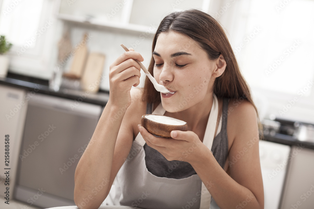 woman eating yogurt woman eating yogurt