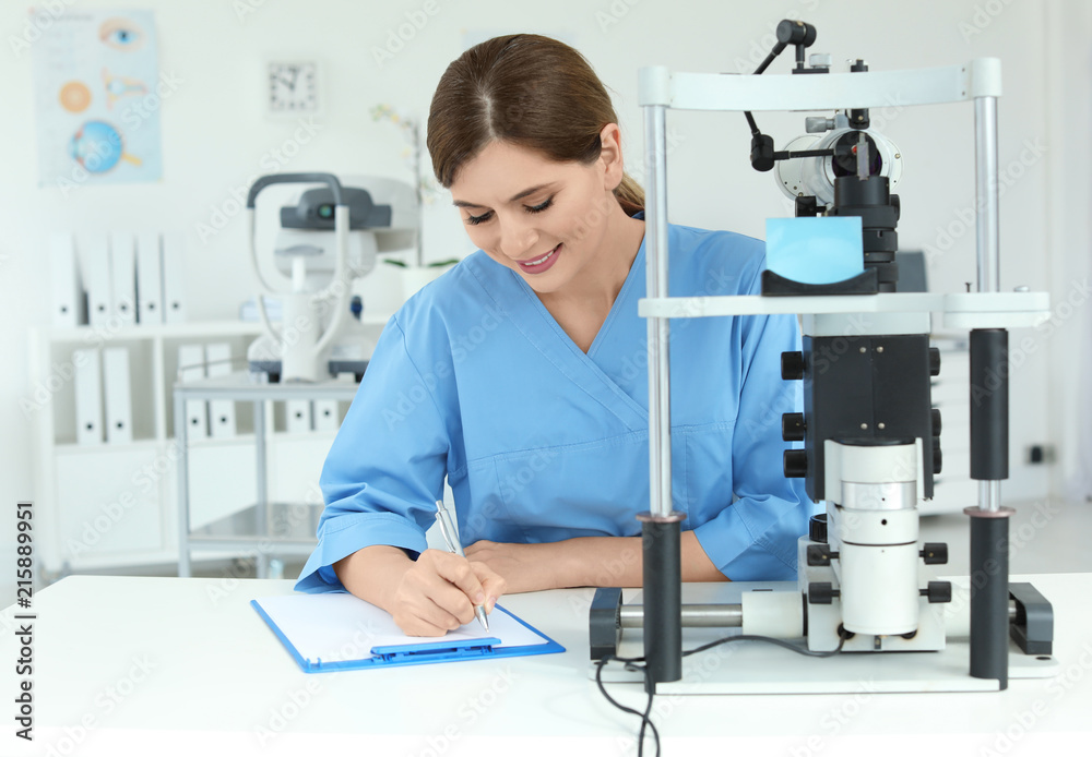 Ophthalmologist with modern equipment in clinic Ophthalmologist with modern equipment in clinic