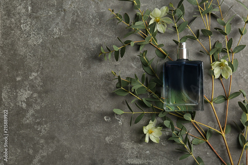 Beautiful composition with bottle of perfume on grey background, flat lay