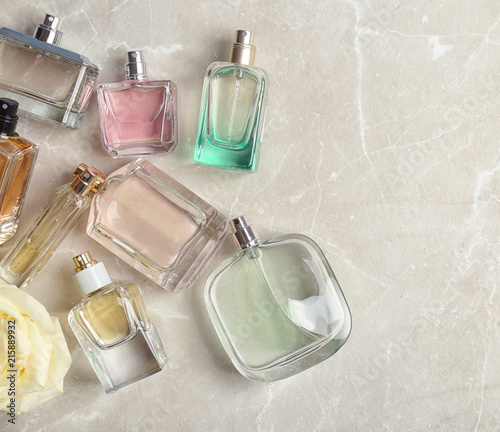 Perfume bottles on light background, flat lay