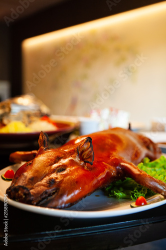 Delicious, Golden Roasted BBQ Suckling pig Cantonese Style made from a piglet that turned into Chinese delicacy which its cooked skin is very crispy and the meat is tender and juicy. Selective Focus.