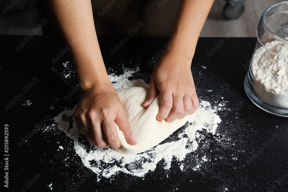 Woman kneading dough for pastry on table Woman kneading dough for pastry on table