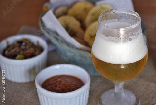 Bar food: glass of beer with appetizers photo
