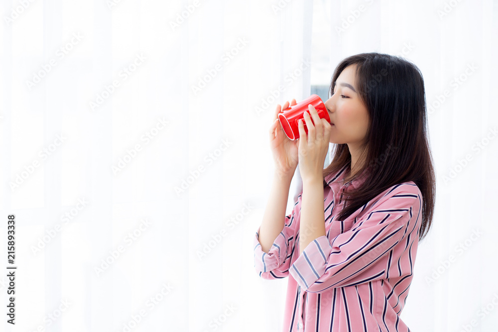 Beautiful of portrait young asian woman with drink a cup of coffee standing curtain window background in bedroom, girl relax in morning at home, lifestyle concept. Beautiful of portrait young asian woman with drink a cup of coffee standing curtain window background in bedroom, girl relax in morning at home, lifestyle concept.