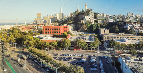 Panorama aerial view Embarcadero boulevard and Telegraph Hill neighborhood from Pier 39 at sunset. Coit Tower is located at the top of the hill, San Francisco, California, USA