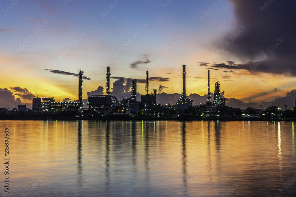 Silhouette oil refinery and Petrochemical plant at dusk at sunrise
