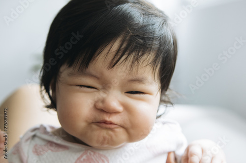 Baby girl making funny face photo