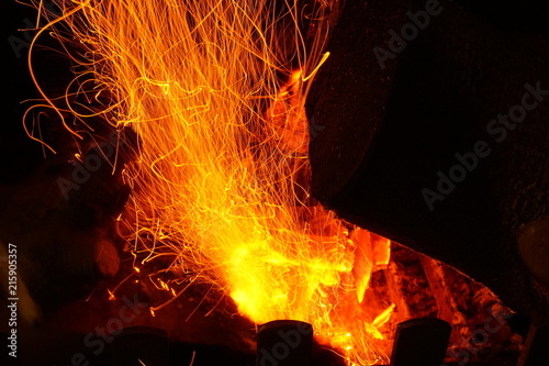 Sparks flying from burning coals