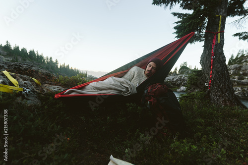 Man Waking Up In Hammock In Mountains photo