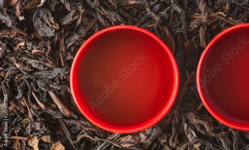 close-up of a cup of chinese tea on dry tea leaves background