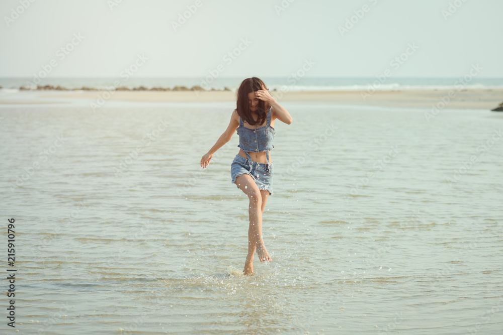 Portrait of beautiful asian woman happy on beach, playful, dancing, running, summer vacation, sunny, having fun, positive mood, Happy girl running on the beach. Portrait of beautiful asian woman happy on beach, playful, dancing, running, summer vacation, sunny, having fun, positive mood, Happy girl running on the beach.