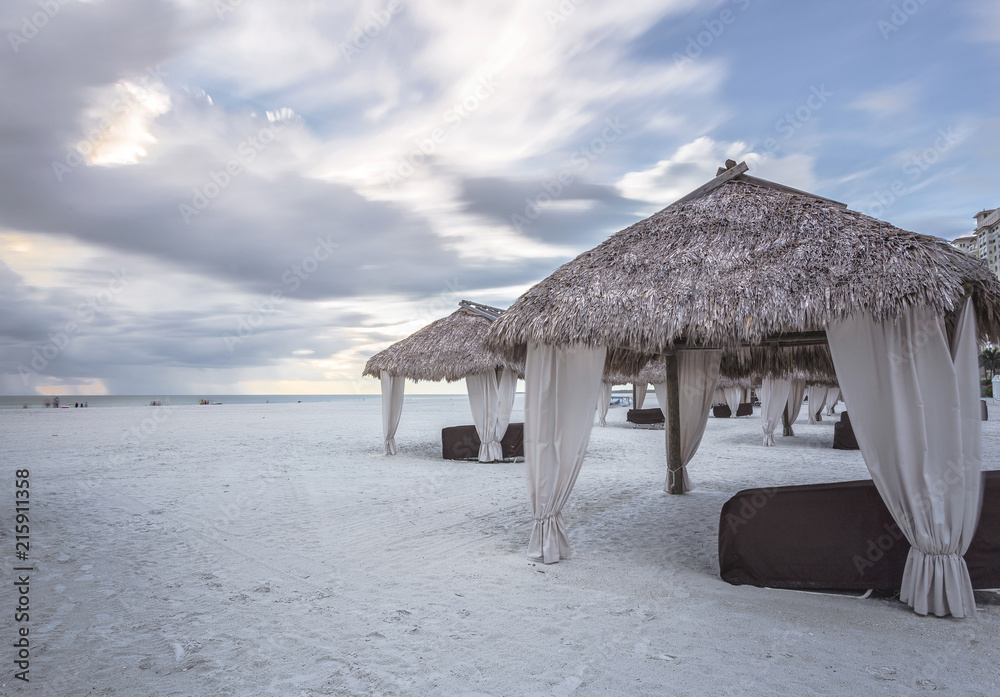 Long extension beaches and calmed sea at Marco Island Beach, Gulf of Mexico, Florida, USA. Palm Thatch at the beach. Stormy day in this amazing beach in southern Florida. Long extension beaches and calmed sea at Marco Island Beach, Gulf of Mexico, Florida, USA. Palm Thatch at the beach. Stormy day in this amazing beach in southern Florida.