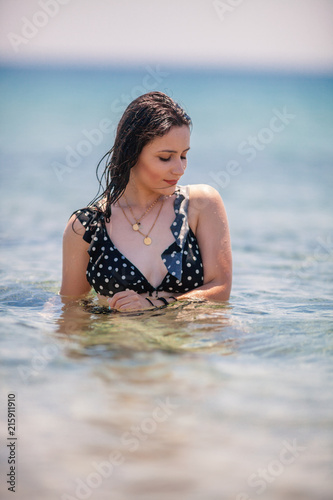Sexy Young Girl posing at the beach inside the sea