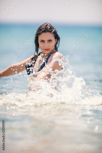 Sexy Young Girl posing at the beach inside the sea