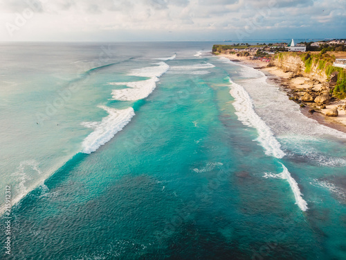 Beautiful tropical coastline with turquoise ocean and waves in Bali. Aerial view © artifirsov