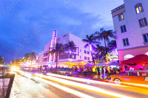 Ocean Drive scene at sunset with lights, palm trees, cars and people having fun, Miami beach. Art Deco style hotels and restaurants at sunset on Ocean Drive, world famous destination for its nightlife © poladamonte