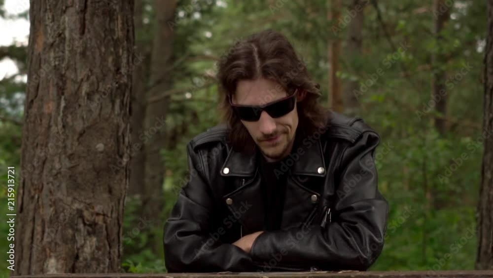the guy in the leather jacket and glasses