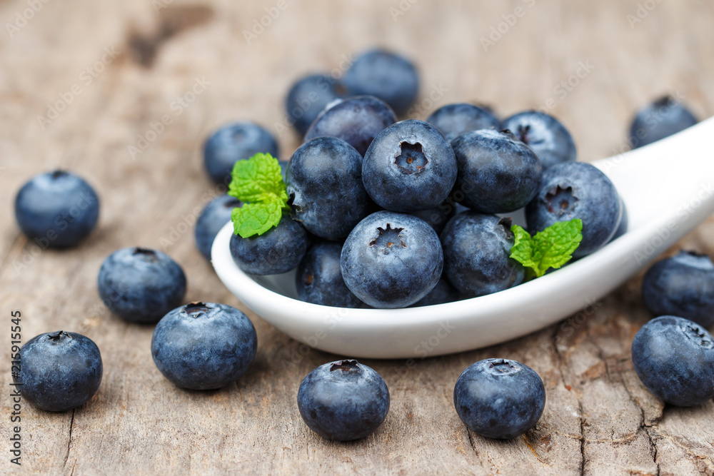 Blueberries in white spoon on wooden table, Healthy eating and nutrition concept Blueberries in white spoon on wooden table, Healthy eating and nutrition concept