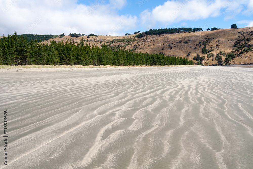Sand patterns on the beach at Okains Bay, South Island, New Zealand Sand patterns on the beach at Okains Bay, South Island, New Zealand