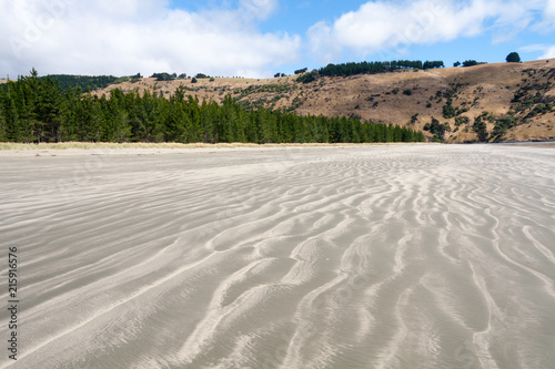 Sand patterns on the beach at Okains Bay, South Island, New Zealand