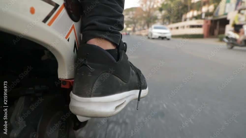 Foot of Person riding a motorcycle - Close up Foot of Person riding a motorcycle - Close up