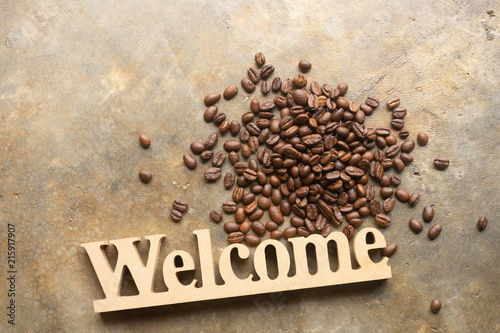 Decorative letters word welcome with coffee bean on texture background for cafe.