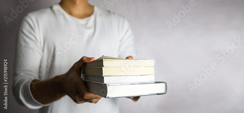 Man holding stack of book