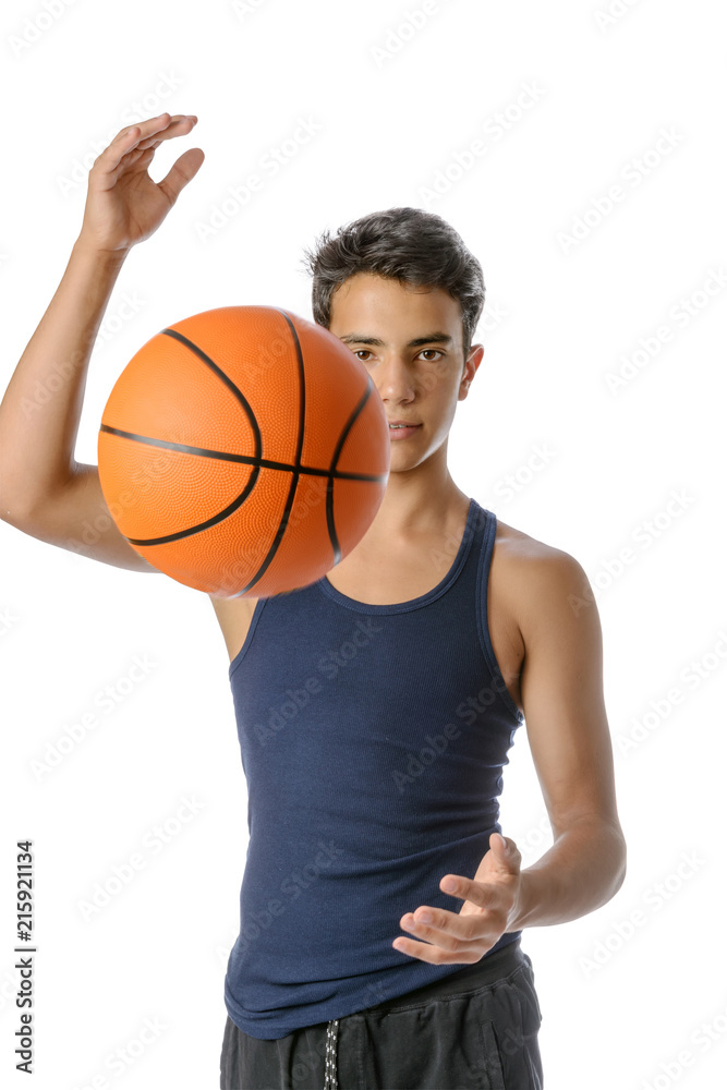 Teenager  with sportswear playing basketball. White background.