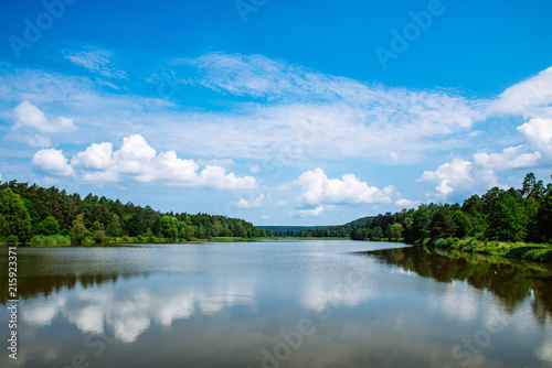 landscape view of lake in sunny summer day. sky reflection in water