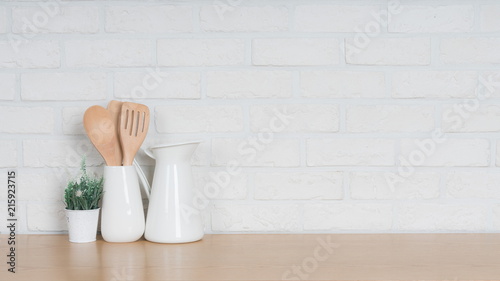 Kitchen utensils and dishware on wooden shelf. Kitchen interior background.Text space.