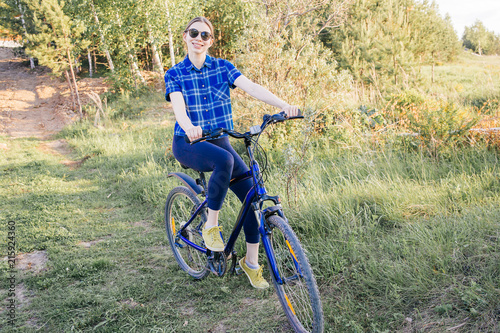Young woman riding a bike © Nichizhenova Elena