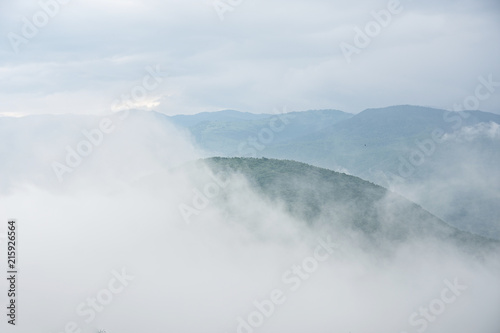 Mountains in magical cloudy sky