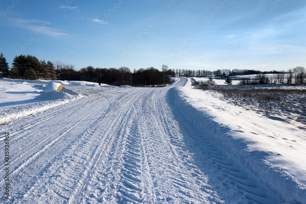 Snowy road in countryside.