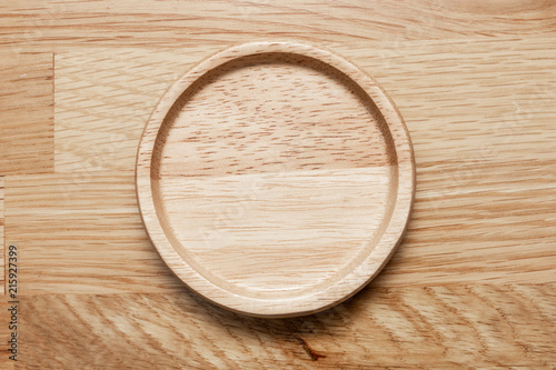 Empty wooden plate with the soft wood background.