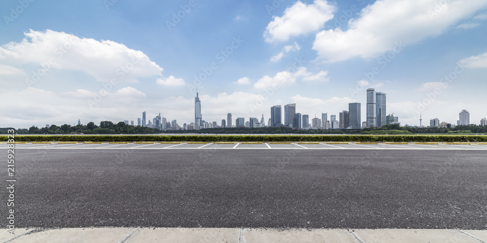 Fototapeta premium Panoramic skyline and modern business office buildings with empty road,empty concrete square floor