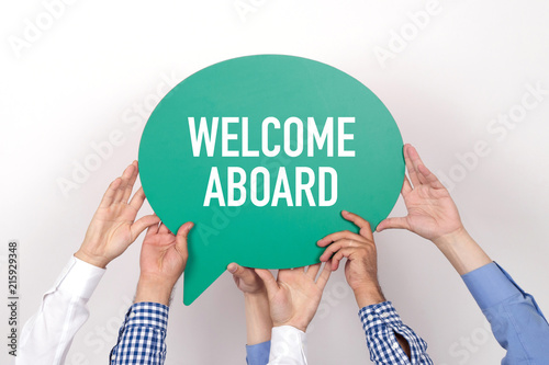 Photography Group of people holding the WELCOME ABOARD written speech bubble
