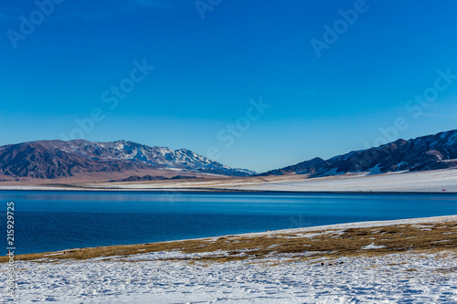  The frozen Sailimu lake with snow mountain background at Yili, Xinjiang of China
