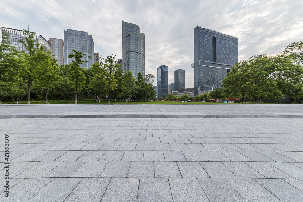 Panoramic skyline and modern business office buildings with empty road,empty concrete square floor Panoramic skyline and modern business office buildings with empty road,empty concrete square floor